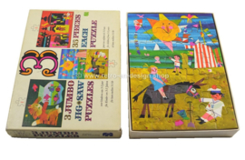 Box containing three vintage Jumbo jigsaw puzzles
