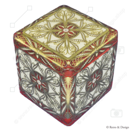 Tin in a cube shape with relief decorations in white, red and gold