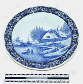 Extra-large Delft Blue wall plate with a river landscape in winter by Royal Sphinx Maastricht and Petrus Regout. Signed J. Sonneville