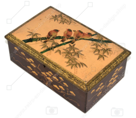 Rectangular tin drum on which birds on a branch and leaf motifs in relief, with lock
