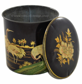 Round vintage tin canister decorated with cranes