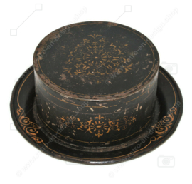 Antique round decorative tin with accompanying saucer