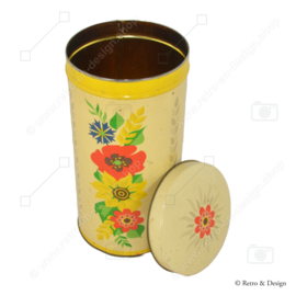 Cylindrical yellow vintage biscuit tin from Verkade, with colored flowers