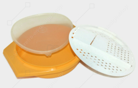 Vintage Tupperware slicing bowl in yellow with white grater and transparent lid