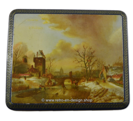 Vintage tin with an image of a painting with a winter scene