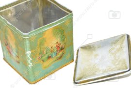 Vintage tea tin in cube shape with handle and romantic scenes