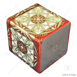Tin in a cube shape with relief decorations in white, red and gold