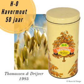 ​Round vintage tin for porridge with images of oats and text "H-O Havermout 50 jaar"