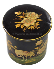 Round vintage tin canister decorated with cranes