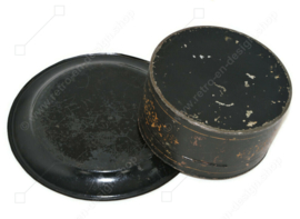 Antique round decorative tin with accompanying saucer