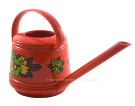 Red vintage plastic Emsa watering can with floral decoration