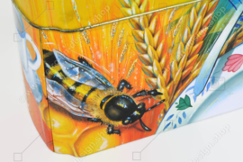 Orange and blue tin box for Wasa Crackers with images of a rooster, bee, sunflower, grain and fruit