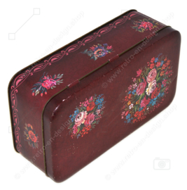 Rechteckige Vintage dunkelrote Blechdose mit mehrfarbigem Blumenmuster und Knistern