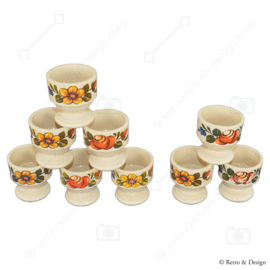 Set of nine vintage plastic Emsa egg cups with floral pattern