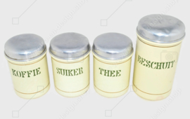 Set of four cream-coloured brocante enamelled storage containers for coffee, sugar, tea and rusk with reseda green letters