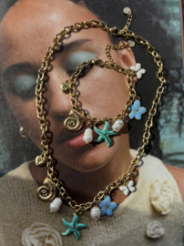 Bedel ketting van RVS (stainles steel) Goudkleurig met blauw/turquoise zee bedels en pareltjes.