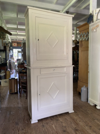 Zandkleurige brocante kast in twee delen.