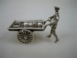 Zilveren miniatuur kachelsmid met handkar met draaiende wielen uit ca.1977