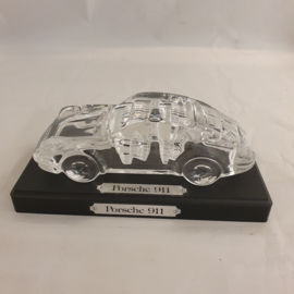 Porsche 911 made of crystal glass on a wooden pedestal