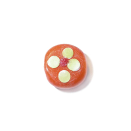 Orange flat glassbead with yellow and red projection