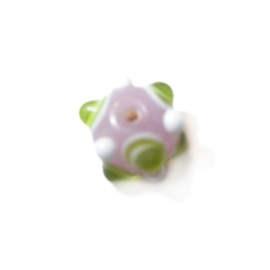 Light purple glass bead with green and white dots