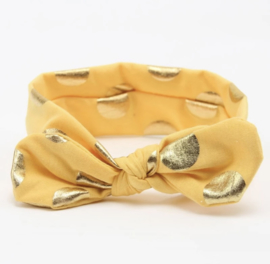 Vrolijke gele haarband met gouden stippen