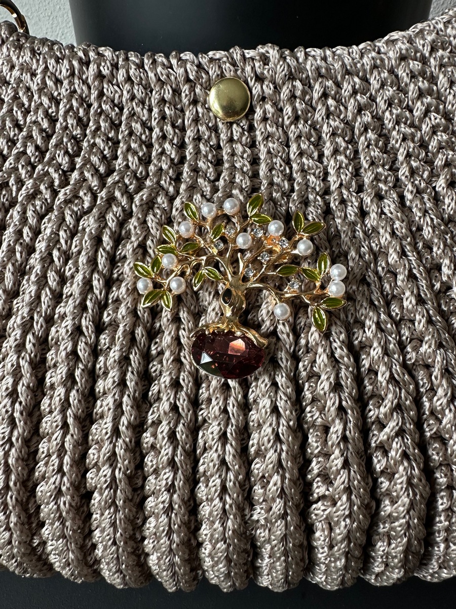 Bag with a brooch in beige