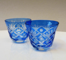 A pair of blue cut to clear crystal cordial glasses