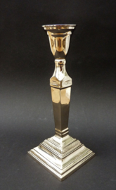 A pair of chrome plated candlesticks in neo classical style