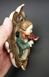 Bisque Biedermeier style porcelain wall hangers boy playing violin singing girl