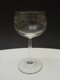 A pair of guilloche engraved wine glasses