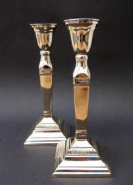 A pair of chrome plated candlesticks in neo classical style