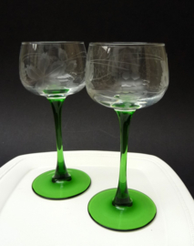 A pair of Luminarc France white wine glasses green stem etched vines
