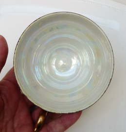 Lusterware tea cup with feet and reticulated saucer
