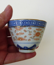 A pair of Chinese Wanyu rice grain porcelain tea bowls
