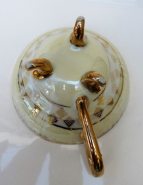 Lusterware tea cup with feet and reticulated saucer