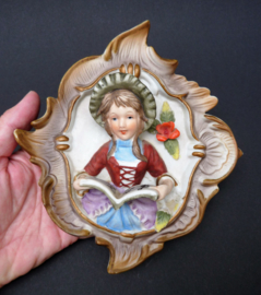 Bisque Biedermeier style porcelain wall hangers boy playing violin singing girl