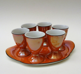 Art Deco oranje lusterware porseleinen eierdopjes op schaal