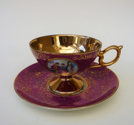 Gilded porcelain Fragonard Courting Couple cup with saucer