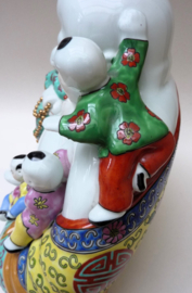 Large Chinese porcelain sitting Budai with five playing boys