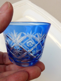 A pair of blue cut to clear crystal cordial glasses