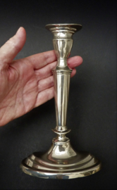 A pair of white metal neo classical style candlesticks