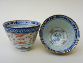 A pair of Chinese Wanyu rice grain porcelain tea bowls