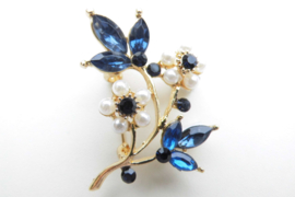 Broche blauw/witte bloemen.