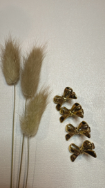 2 haarklemmetjes goud met strik 3 cm .
