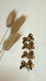 2 haarklemmetjes goud met strik 3 cm .