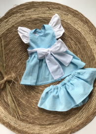 Vrolijke jurk met bijpassende bloomer in aqua met wit.