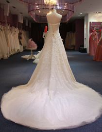 Dalia: Sunny A-line wedding dress, beautifully decorated with lace flowers with a pearl heart. Price: € 920