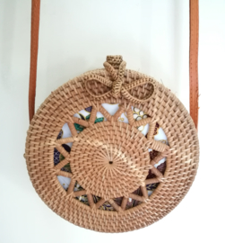 Meesterlijk vlechtwerk dit opengewerkte rotan tasje.  Prachtig afgewerkte sluiting; draagband van bruin leer. Lengte band 1.25 cm. Sluit met sierlus. Diameter 20 cm, 8 cm diep.