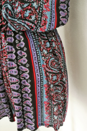 Korte zomerse mouwloze jumpsuit 'Bali Art'. Met grappige brede strikband op de rug, die over over de bh. band valt. Elastische taille en mooi uitgesneden rug. 100% zachte rayon. maat 36 t/m 40